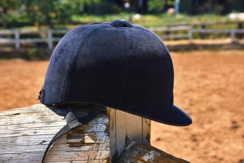 riding helmet on fencepost