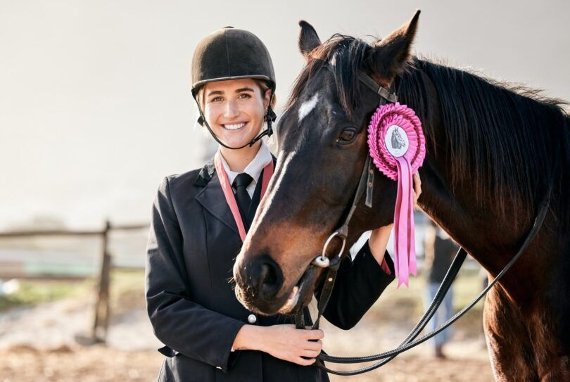equestrian woman with a ribbon on horse