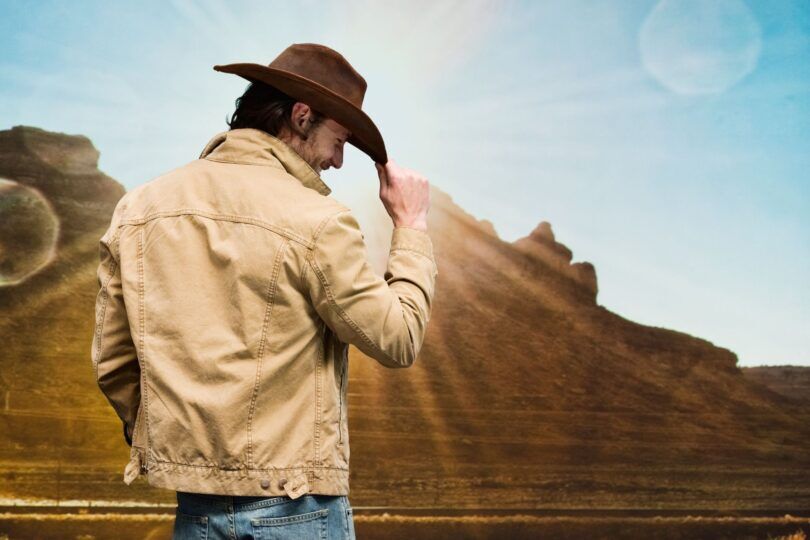 man tipping cowboy hat