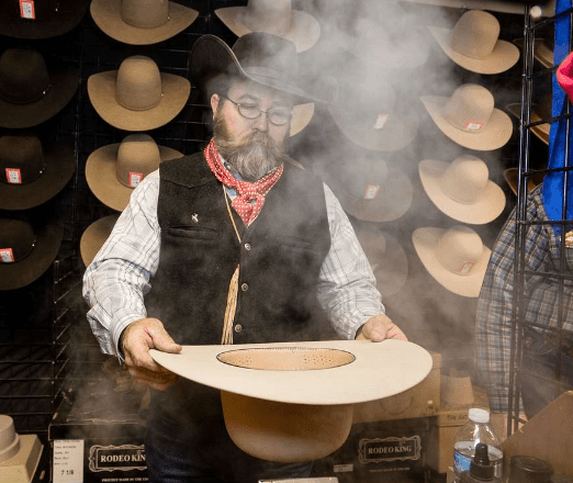 man steaming a cowboy hat