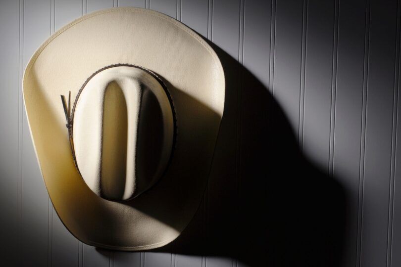 cowboy hat hanging on wall hook