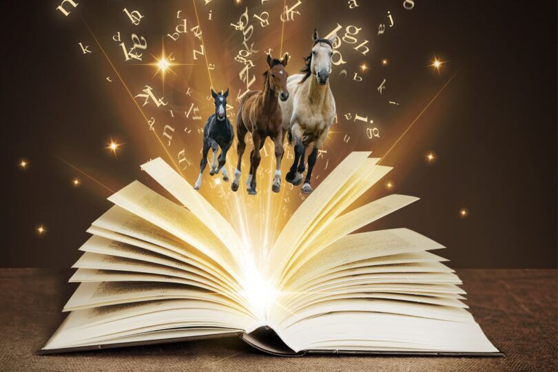 horses galloping out of a glowing book